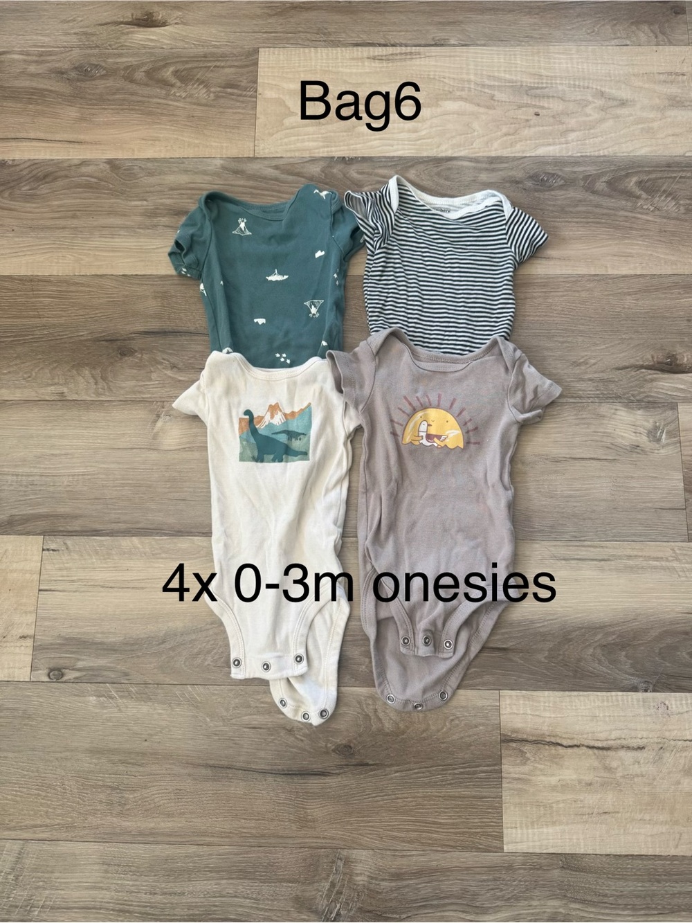 Lot: 4 onesies and 3 sleep sacks- 0-3M